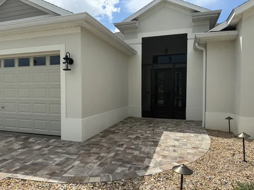 Matching pavers curving to the front entry of the same Villages home